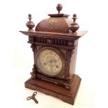 A Victorian carved oak mantel clock, 35cm tall