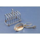 A small silver toast rack, Birmingham 1903 and a 830 standard silver spoon with curled handle