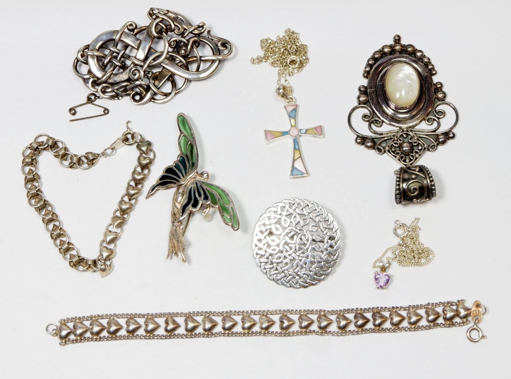 A group of silver jewellery including two heart formed bracelets, three brooches including a