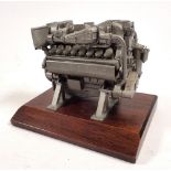 A miniature model V16 Diesel engine on plinth, 12.5cm wide