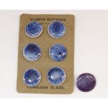 A Ruskin set of six blue roundel buttons on original card plus one other