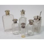 Three silver topped toiletry bottles, two cut glass and silver plated cruet bottles and a cut