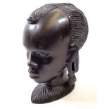 An African amboyria carved wood head, 23cm tall