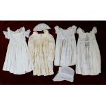 An Edwardian silk childs dress, three white cotton christening gowns and two bonnets