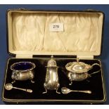A silver three piece cruet set, boxed 24 x 11.5cm, Birmingham 1925 by William Suckling Ltd.