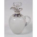 A glass claret decanter with silver spout and collar, 21cm tall, London 1913, William Comyns & Sons