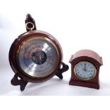 A walnut veneered mantel clock, 12.5cm tall plus a circular barometer, 19cm