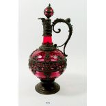 A late 19th century pewter clad cranberry glass Renaissance style ewer with stopper, 33cm tall