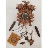 A carved wood cuckoo clock