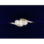 An Edwardian gold crossover ring set three diamonds, size O-P, probably 18 carat - marks worn, 2.1g