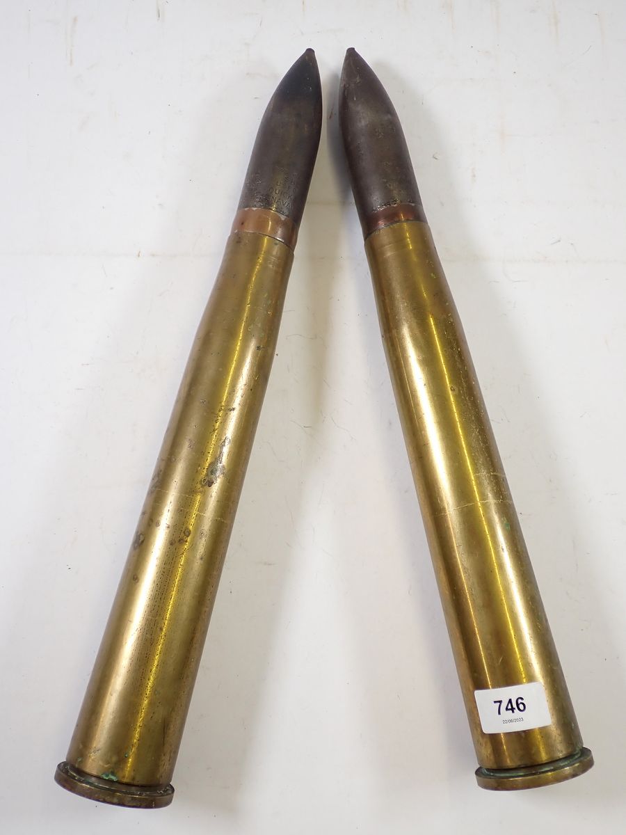 A pair of military trench art naval two pounder shells in brass casings, 45cm