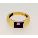 An 18 carat gold ring with wide shank set rectangular cut amethyst size I-J, 7.3g