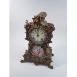 A 19th century gilt metal mantel clock inset porcelain panel painted classical scene with Ansonia