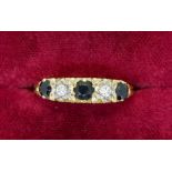 An 18 carat gold ring illusion set two diamonds and three sapphires, 33g, size P