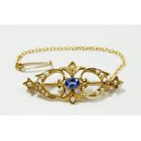 A gold openwork brooch set seed pearls, two diamonds and Ceylon sapphire, unmarked 3.5cm long, 2.9g