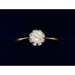 An 18 carat gold and platinum set diamond solitaire ring, marks worn, size N