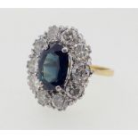 An 18 carat gold large oval sapphire and diamond set ring, size M, 5.3g