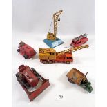 A group of Dinky construction vehicles including cranes, bulldozer, tractor and a fire engine
