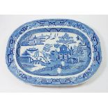 An antique blue and white Staffordshire Stone China willow pattern meat plate, 44.5cm long