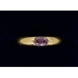 An 18 carat gold ring set oval cut amethyst and inset small diamond, size J, 4.4g