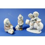 Three Lladro figures, children riding a polar bear, a child with polar bear and a child petting a