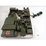 A collection of Dinky military vehicles including tank, trucks, jeeps, guns etc.