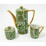 A green and gilt paisley coffee pot, sugar and milk jug