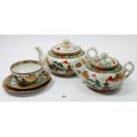 A Japanese teaset comprising teapot, lidded two handled sugar bowl, seven cups, eight saucers and