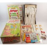 A box of vintage packaging items including Ideal Giggles cardboard doll box, Golden Syrup tins,