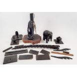 A box of carved ebony items including African elephant, table lamp etc.