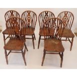 A set of six wheel back dining chairs on turned supports