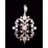 A Victorian silver and gold set openwork diamond pendant with optional screw brooch fitting and