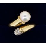 An 18 carat gold crossover ring set pearl and white stone, size L, 6g