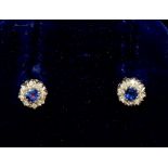 A 9 carat white gold pair of sapphire and diamond earrings (studs) 6mm total diameter