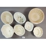A group of eight jelly moulds including one by Shelley featuring lobster and shell design, 14.5 x