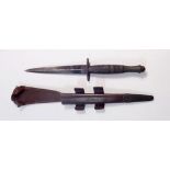 A Fairbairn Sykes Commando knife in leather sheath