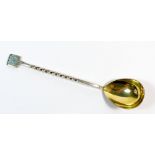 A Russian silver caviar spoon with gilt bowl and enamel terminal, 916 standard, 15cm