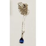 An 18 carat white gold pendant set pear cut Ceylon sapphire and small diamond, on 18 carat white