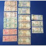 A wad of world banknotes, examples include: Barbados $5 1975, Colombia 5 pesos 1961-81, Hong Kong: