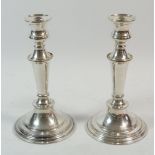 A pair of silver plated candlesticks, 21cm tall