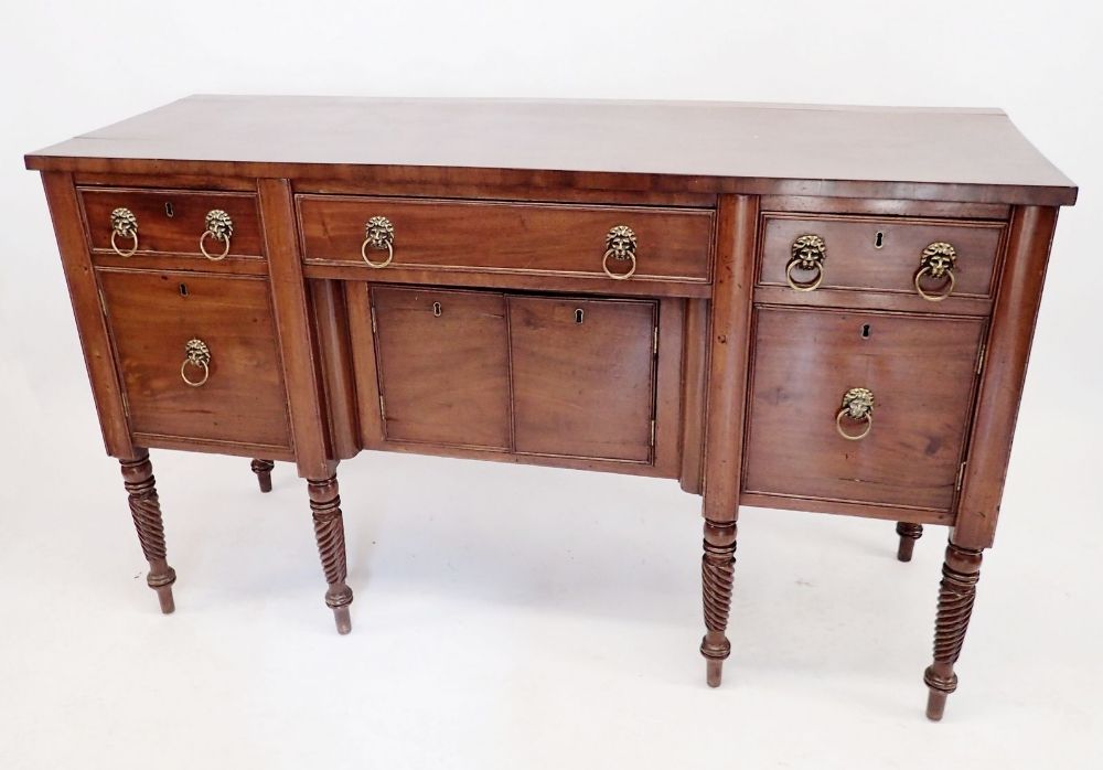A Regency mahogany sideboard on turned supports with low back over three frieze drawers and four