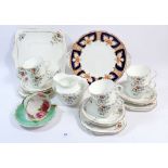 A Heathcote bone china tea service with enamel floral decoration comprising: six cups and saucers,