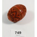 A coquilla nut carved into an egg form pomander