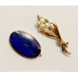 A 9 carat gold oval lapis lazuli oval vine pendant and a gold pearl flower brooch (unmarked)