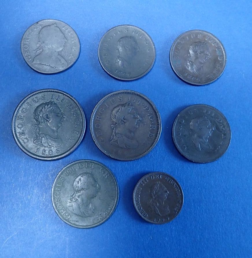 A quantity of copper/bronze coinage, 8 total including: George III farthing 1799, halfpennies