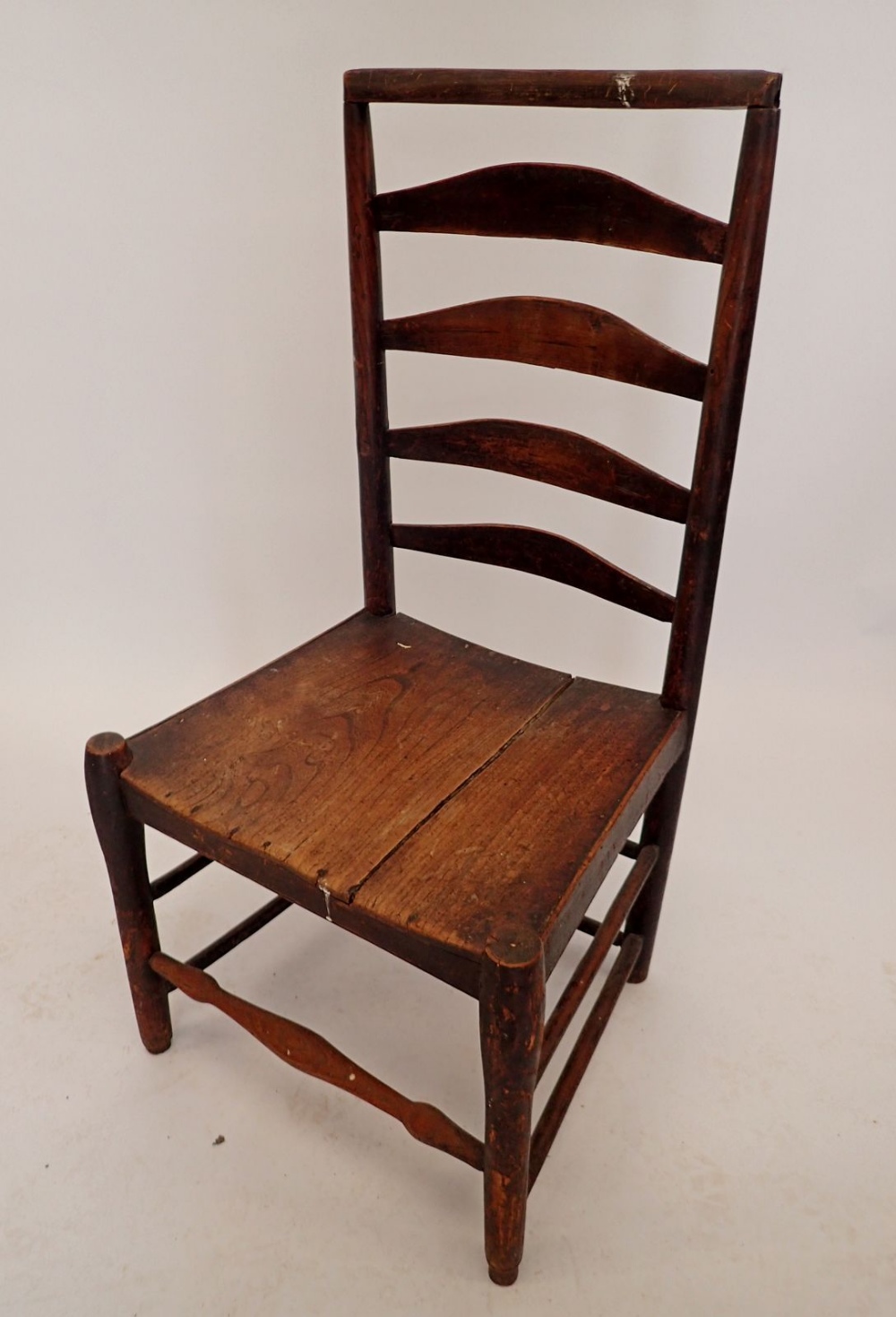 A provincial ladder back chair with elm seat