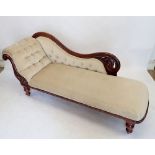 A Victorian mahogany chaise longue with carved scrollwork back and turned supports, 180cm wide x