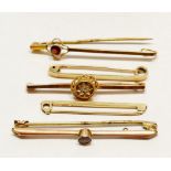 Two 9 carat gold bar brooches and another set diamond a/f plus 9 carat gold ties pins, 10g