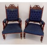 A pair of Victorian carved frame mahogany salon chairs with blue upholstery
