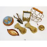 A collection of brass and metal items including two brass hand clips, a cast stags head door